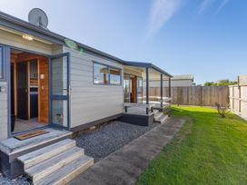 An outdoor area with steps leading to a door at Seabreeze Surf House - Whitianga