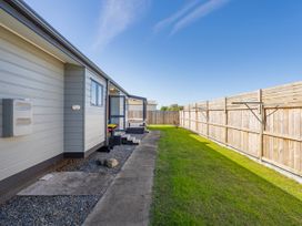 An outdoor area with a pathway and grass at Seabreeze Surf House - Whitianga Escape