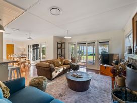 A living room with a sofa and coffee table at Waterside Bliss - Taupo Holiday Home Taupo Central