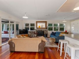 A living room with a couch and television at Waterside Bliss - Taupo Holiday Home Taupo Central