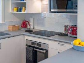 A kitchen with a kettle and toaster at Waterside Bliss - Taupo Holiday Home in Taupo Central