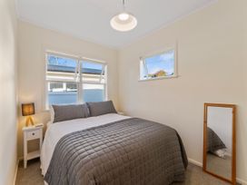 A bedroom with a bed and lamp at Waterside Bliss - Taupo Holiday Home Taupo Central