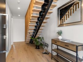 A hallway with a staircase and furniture at Tauranga Holiday Home Tauranga