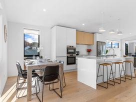 A kitchen with a table and chairs at Tauranga Holiday Home in Tauranga