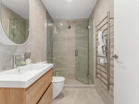 A bathroom with a sink, shower, and toilet at Tauranga Holiday Home, Tauranga