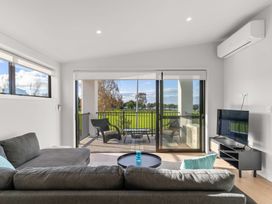 A living room with a sofa and coffee table at Tauranga Holiday Home in Tauranga