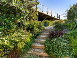 A pathway with steps leading to a building at Island Views - Waihi Beach Holiday Home Waihi Beach