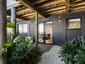 An outdoor area with plants and access to a room at Island Views - Waihi Beach Holiday Home Waihi Beach