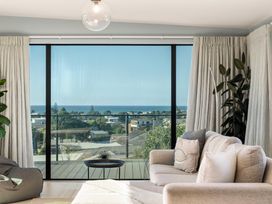 A living room with a view of the ocean at Island Views - Waihi Beach Holiday Home in Waihi Beach
