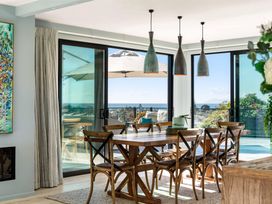 A dining room with a table and chairs at Island Views - Waihi Beach Holiday Home, Waihi Beach