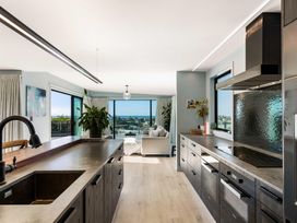 A kitchen with a sink and stove at Island Views - Waihi Beach Holiday Home Waihi Beach