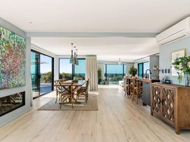 A dining room with a table and chairs at Island Views - Waihi Beach Holiday Home Waihi Beach