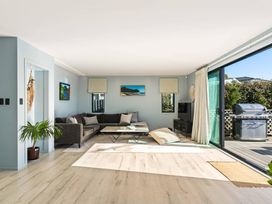 A living room with a sofa and coffee table at Island Views - Waihi Beach Holiday Home Waihi Beach