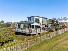 A house with a deck and outdoor seating at Island Views - Waihi Beach Holiday Home, Waihi Beach