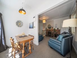 A dining area with a table and chairs at Fiordland Hideaway - Te Anau
