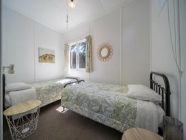A bedroom with two beds and a window at Fiordland Hideaway - Te Anau