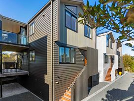 A building with balconies and staircases at Waihi Beach Holiday Home in Waihi Beach