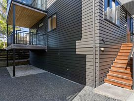 An exterior view of a building with a balcony and staircase at Waihi Beach Holiday Home Waihi Beach