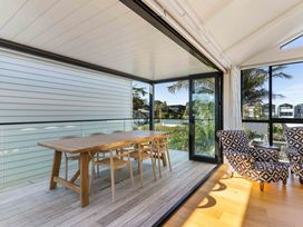 A dining room with a table and chairs at Waihi Beach Holiday Home Waihi Beach