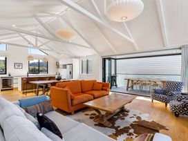 A living room with a sofa and coffee table at Waihi Beach Holiday Home in Waihi Beach
