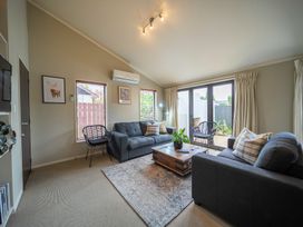A living room with sofas and a coffee table at Te anau holiday home in Te Anau