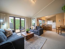 A living room with sofa and coffee table at Te anau holiday home in Te Anau