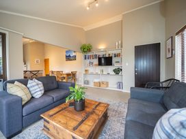 A living room with a coffee table and seating at Te anau holiday home in Te Anau