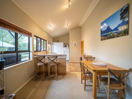 A kitchen with a table and chairs at Te anau holiday home in Te Anau