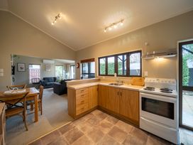 A kitchen with a stove and sink at Te anau holiday home Te Anau