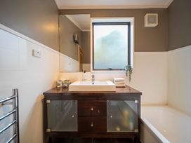 A bathroom with a sink and mirror at Te anau holiday home in Te Anau