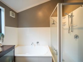 A bathroom with a bathtub and shower at Te anau holiday home in Te Anau