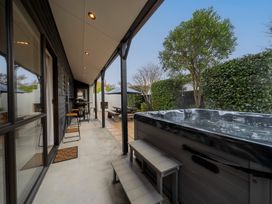 An outdoor area with a hot tub and patio furniture at Te anau holiday home in Te Anau