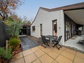 A outdoor area with a table and chairs at Te anau holiday home Te Anau