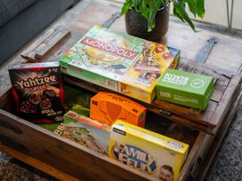 A coffee table with board games at Te anau holiday home in Te Anau
