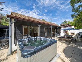 An outdoor area with a hot tub and seating at Te anau holiday home in Te Anau