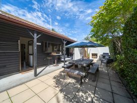 An outdoor dining area with a table and chairs at Te anau holiday home Te Anau