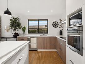 A kitchen with sink, oven, and plants at Mako Haven - Mountain Outlook in Wanaka