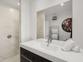 A bathroom with a sink and shower at Mako Haven - Mountain Outlook Wanaka
