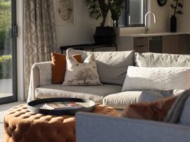A living room with a sofa and coffee table at Mako Haven - Mountain Outlook in Wanaka