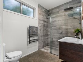 A bathroom with a shower, sink, and toilet at Sweet Seabreeze - Mangawhai Heads Holiday Home, Mangawhai