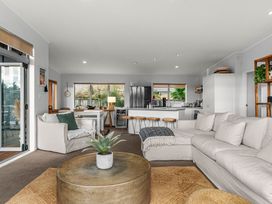 A living room with a couch and coffee table at Sweet Seabreeze - Mangawhai Heads Holiday Home in Mangawhai
