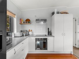 A kitchen with appliances and storage at Sweet Seabreeze - Mangawhai Heads Holiday Home, Mangawhai