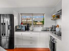A kitchen with appliances and countertop at Sweet Seabreeze - Mangawhai Heads Holiday Home in Mangawhai