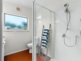 A bathroom with a shower and toilet at Sweet Seabreeze - Mangawhai Heads Holiday Home, Mangawhai