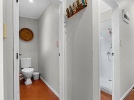 A bathroom with a toilet and shower at Sweet Seabreeze - Mangawhai Heads Holiday Home in Mangawhai