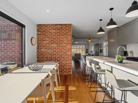 A kitchen with a dining table and stools at Cromwell Holiday Home in Cromwell