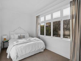 A bedroom with a bed and a window at Cromwell Holiday Home in Cromwell