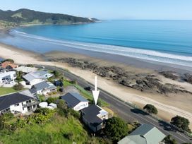 An aerial view of houses and beach at Ahipara in Kaitaia