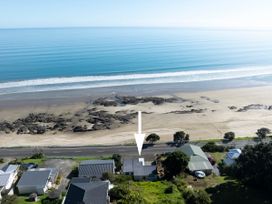 An aerial view of a beach and houses at Ahipara in Kaitaia