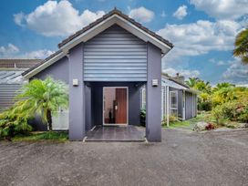 An entrance with a door and plants at Solar House - Kerikeri Holiday House in Kerikeri
